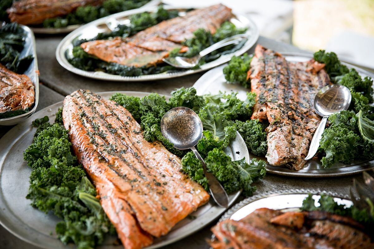 Herb-crusted salmon fillets on kale platters